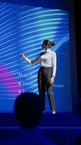 Live Event Stage: Female Speaker Presents New Product, Screen SHows Neural Networks, Artificial Intelligence, BigData and Machine Learning. Audience Applauds. Video with Vertical Screen Orientation