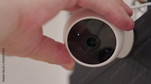 Smart home security, using wireless ip cameras in house to record surveillance video, installation and adjustment hidden home security camera in apartment close-up. High quality 4k footage
