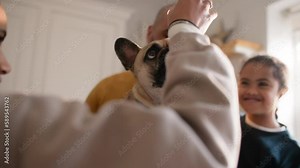 Family and boy with Down syndrome training dog with treat