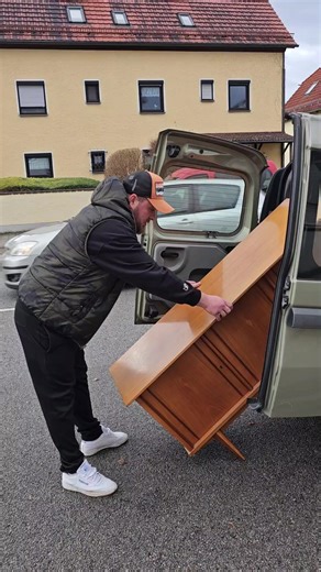 Effortlessly Carrying a Large Wooden Cabinet