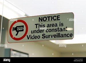 A security sign at an Airport terminal warns of constant video camera surveillance Stock Photo - Alamy