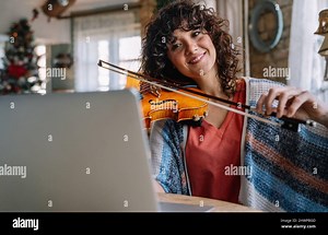Woman music teacher teaching how to play a song the violin online during a video call Stock Photo - Alamy