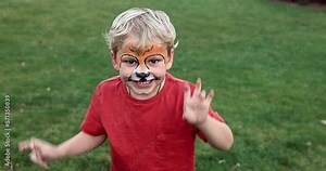 Cute little boy with face paint. Face painting, kid painting face at the birthday party or on holidays