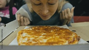 Girl eat pizza cheese four. Close up of young woman mouth greedily eating pizza and chewing in outdoor restaurant. Human hands taking pieces slices of hot tasty italian pizza from open box. Junk food.