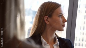 Blonde business woman in a meeting with her colleagues listening intently to the ongoing discussion