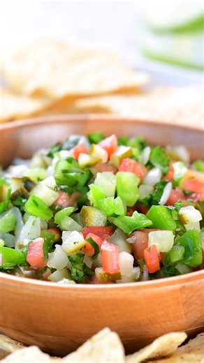 This fresh Dill Pickle Salsa recipe is easy to make and full of flavor! Serve with tortilla chips or on top of tacos, burgers, and hot dogs. https://www.thegunnysack.com/dill-pickle-salsa/ #dillpickles #picodegallo #HomemadeSalsa | The Gunny Sack