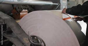 Plant on production of newspaper. Print machine roll in newspaper offset print production. Worker man in working in newspaper factory