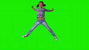 Smiling girl jumping up and down on green screen | Free Stock Video Footage