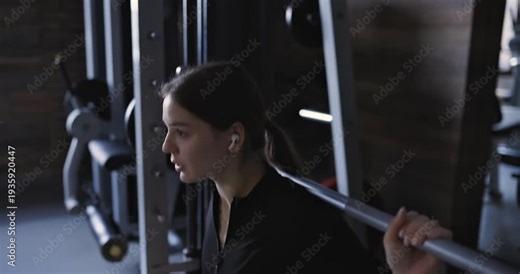 Smith machine squats, woman at the gym, slow motion