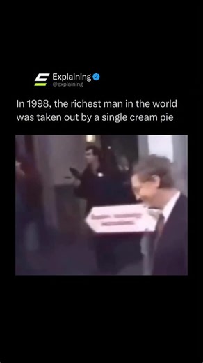 Explaining on Instagram: "In 1998, while visiting Brussels, Belgium, Bill Gates was famously hit in the face with a cream pie by a prankster as he entered a meeting. The incident, caught on camera, showed Gates momentarily stunned but quickly wiping himself off and moving on without much reaction. It became one of the most replayed lighthearted moments involving the tech billionaire. Let us know your thoughts below! • #reels #explore #comedy #educational"