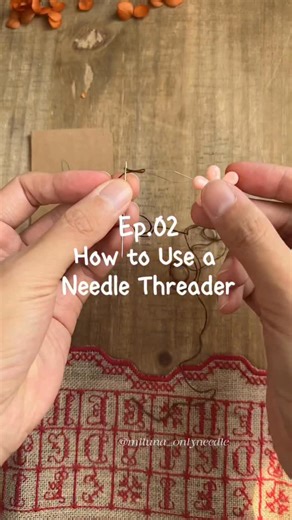 Miluna Onlyneedle on Instagram: "Learn with Me: Intro to Paper Embroidery Ep. 02 | How to Use a Needle Threader A simple tool to save your eyes and keep the creative flow going. 🧵 1️⃣ Through the eye 2️⃣ Thread into loop 3️⃣ Pull back A basic but essential step for our paper embroidery journey. 🍊 #embroidery #paperembroidery #needlethreading #orangetreeproject #handmade"