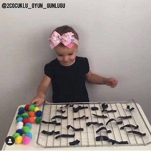 5.7K views · 68 reactions | A super easy to set up fine motor skills activity! Just tape, pom poms, and an oven rack! - Credit: @2cocuklu_oyun_gunlugu on Instagram! | 7 Days of Play | Facebook