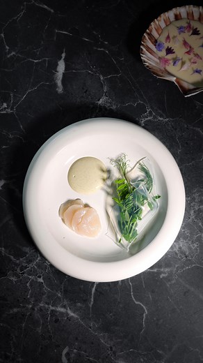 Bri Baker on Instagram: "Scallop, oyster cream, pea tendrils, lemon veil, beurre blanc, and cornflowers, inspired by my favorite dish at @iristherestaurant For me, the best restaurants are the ones that open my eyes to new possibilities with food and inspire me to create, and the meal I recently had at Iris did exactly that. Anyone who knows me well knows that I love scallops, and I’m still dreaming about their scallop dish (shown in my previous video), which is why I felt compelled to recreate