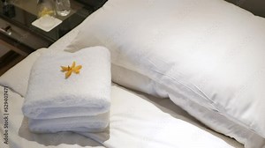 hotel house keeping service brings towels into the bed room put on the bed