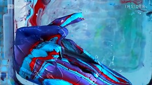 Watch this artist hydro dip sneakers into colorful paints