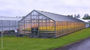Exterior establishing shot of an Iceland greenhouse using geothermal hot water to grow fruits and vegetables.