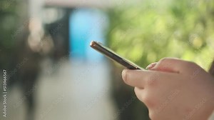 Alternative macro close up of an young businesswoman hands busy working on smartphone for send emails and surf on a web browser.