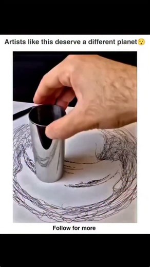 Trend Meme on Instagram: "This artwork is created using a special technique called anamorphic drawing. In this method, the artist intentionally distorts the sketch on the paper so it looks random, messy, and stretched from normal angles. But when a reflective cylinder is placed on the center of the drawing, the curved mirror surface corrects the distortion and reveals the hidden image perfectly. This effect works because the cylinder reshapes the incoming light and aligns all scattered lines int