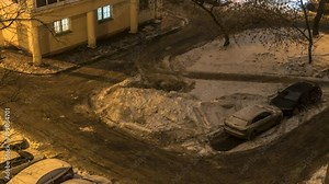 Night Snow loading by road machinery after heavy snowfall in residential block, time lapse