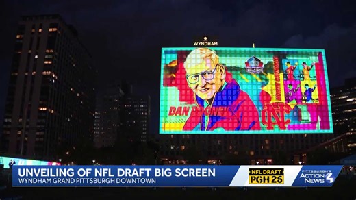 Front of Wyndham Grand transforms into backdrop for NFL draft light projection
