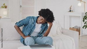 Angry frustrated young African American woman mad about stuck laptop computer, stressed furious lady user feel annoyed about bad software failure, system virus or slow internet speed sit at home