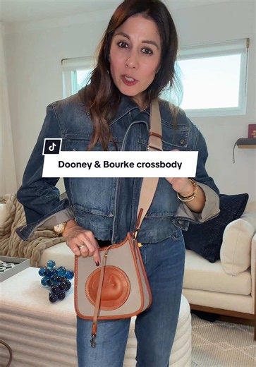 The Dooney & Bourke Duck Messenger Bag features iconic All-Weather Leather that naturally repels water, rich contrasting British Tan trim, and heavy solid brass hardware. It has a secure tongue-tab closure, an exterior back slip pocket, and a built-in interior key leash.#dooneybourkemessengerbag #leathercrossbody #tiktokshopcreatorpicks #qvcloyaltyprogram #dooneyandbourkebag @QVC, Inc