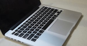 Water slowly drops on the laptop keyboard, causing damage.