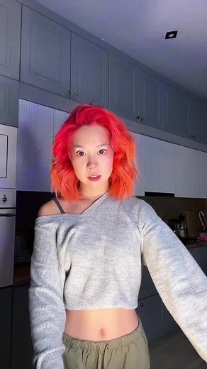 Vibrant Dance Moves in a Modern Kitchen Setting