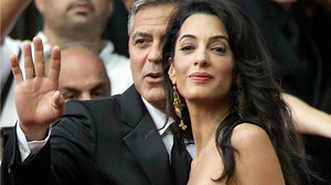 Amal Alamuddin is all smiles as she arrives in Milan ahead of her big wedding day