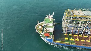 Tender Drilling Oil Rig on Barge Ship transportation Rid to Oil Rig in The Middle of The Ocean at Sunset. Barge Ship transport Big equipment of oil rid.