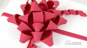 Are you stuck on what to get someone for Christmas? Why not make them a cake and decoarate it to look like a present. Here is a sneak peak on how to make the perfect gumpaste Christmas Gift Bow for the top of your cake! For the full step by step video click here: https://youtu.be/hPrGAnsxxVU | Cakes by Lynz