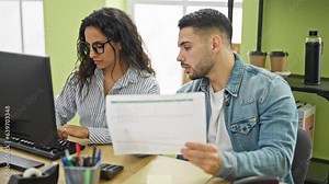Man and woman business workers using computer reading document at the office