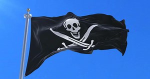 Flag pirate waving at wind in slow with blue sky, loop