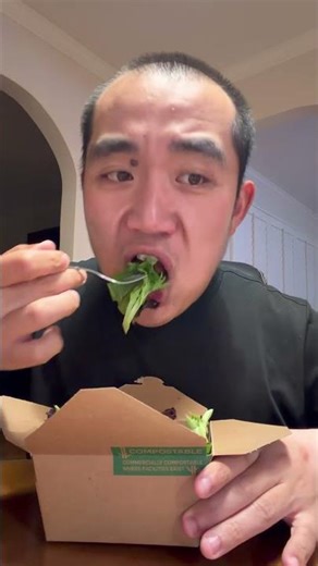 Showing and eating Spring Mix Salad from Whole Foods Market