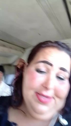 Person with Dark Hair Interacts in Vehicle