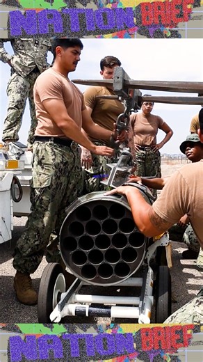 U.S. Marines move and prepare ordnance on AH-64 Apache helicopters