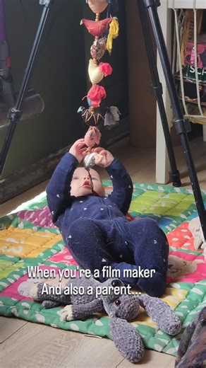 When you're a film maker but also a parent... Oh and living in a small space! You use what you have instead of purchasing new things!! Heres our handy tripod being used as a baby gym 🤣 | Diane and Samson