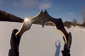 Man throws a handcrafted Batman boomerang.