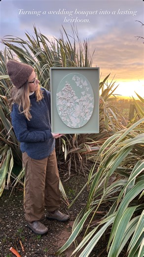 Katy Eccles - Botanical Casting Artist on Instagram: "Turning a wedding bouquet into a lasting heirloom 💐💐💐 A quiet reveal of my latest wedding bouquet preservation commission, captured in the soft early-morning winter light. This large, hand-painted oval cast has been framed in a complementary sage green, chosen to echo the hue of the painted background and honour the original bouquet. #weddingbouquetpreservation #bridalbouquet #weddingkeepsake #flowerpreservation"