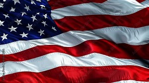 The vibrant American flag flutters in the breeze, displaying its iconic red, white, and blue colors under a clear blue sky Stock Video