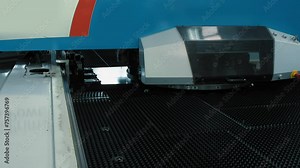 CNC Machine Punching Holes In Metal Sheet To Manufacture Materials For Production Line. Industrial CNC Machine. Metallurgical Punching Press. Automated CNC Machine For Metalwork Punching