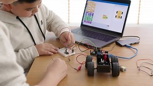 Young asia student remotely learn online at home with parent in coding robot car and electronic board cable in STEM, STEAM, mathematics engineer science technology computer code in robotics for kids.