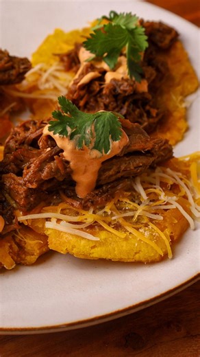 Tasty on Instagram: "Topped tostones take crispy, twice-fried plantains to the next level with juicy shredded beef, melty cheese, and a smoky chipotle-lime sauce. It’s a bold, flavor-packed snack or appetizer that blends Latin street food vibes with ultimate comfort. These bites are perfect for parties, game days, or anytime you want to impress with something crunchy, saucy, and seriously good."