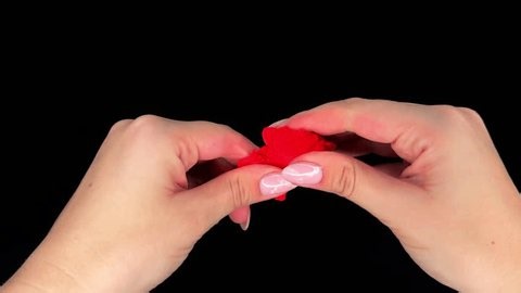 clip-4009062875-hand-kneads-red-modeling-clay-on-black