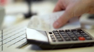 Counting on a calculator. Counting bills, home accounting office