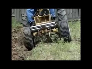 ST16 Sears Tractor Plowing a Garden