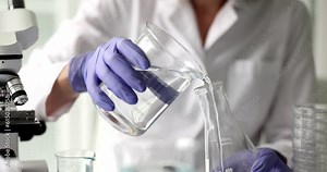 Flask in scientist hand is chemical liquid solvent. Concept of scientific and medical research and development