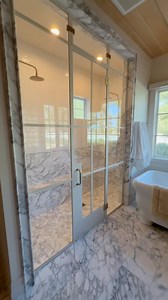 Just completed this dream shower with an amazing shower door. The shower door ties together the entire design. | AFT Construction