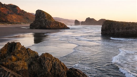 A beach guarded by massive stone towers