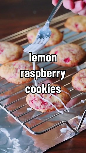 lemon raspberry cookies the full written recipe is on scheckeats.com Ingredients 1/2 cup (113g) unsalted butter at room temperature 1 cup (200g) granulated sugar Zest of 2 lemons 1 egg Juice of 1/2 lemon 1/2 tsp kosher salt 1/4 tsp baking powder 1/8 tsp baking soda 1 1/2 cups (190g) all-purpose flour 3/4 cup (~90g) frozen raspberries, coarsely chopped and stored in freezer until called for in the recipe Juice of 1-2 lemons 1 tbsp butter, melted 2-3 cups powdered sugar